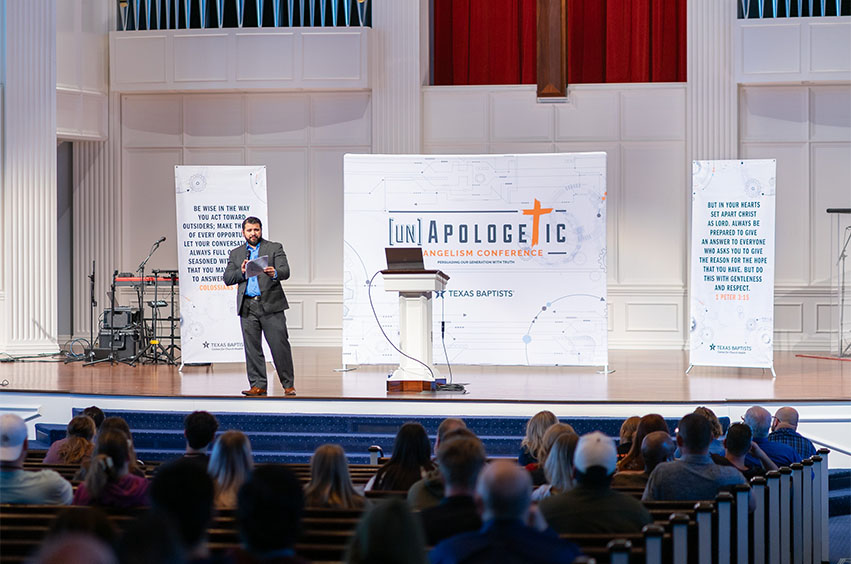 Man standing on DBU stage for the Unapologetics Conference in Dallas, Texas