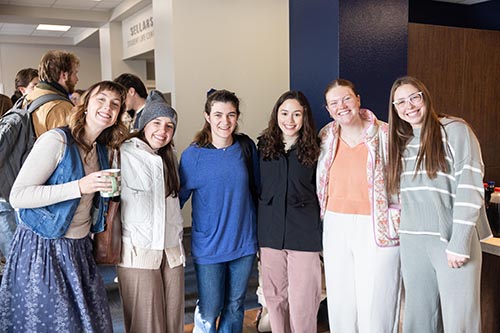 group of DBU students standing inside to stay warm from the Dallas snow