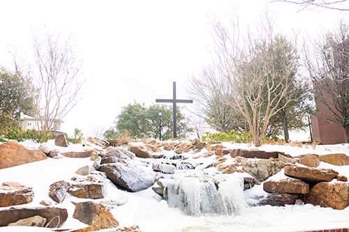 cross showing through the snow