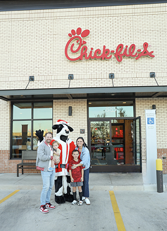 Tyler Haile standing with his family outside of Chick-fil-A