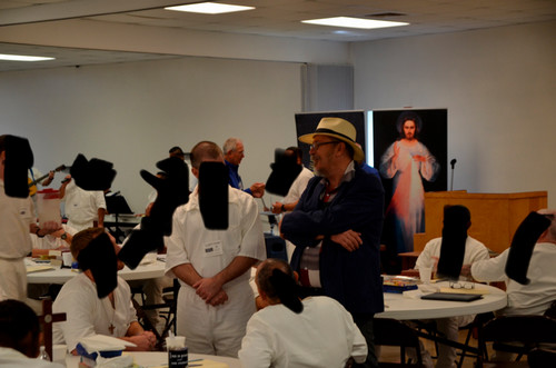 Dr. Fisher ministering to prisoners in a classroom