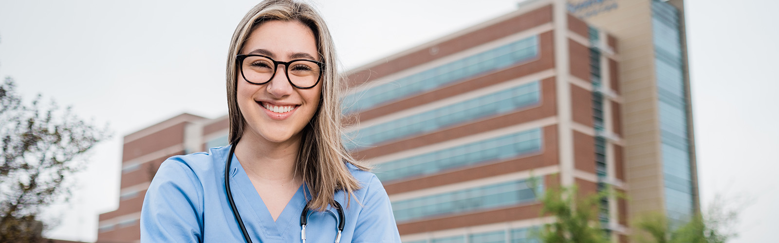 DBU health student posing in front of hospital