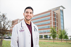 student standing in front of hospital