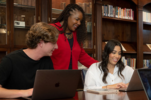 teacher helping students in the classroom