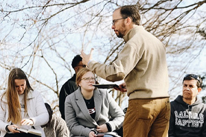 teacher discussing with students outside