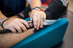 hand holding equipment that is being used on a foot