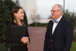 man and a woman speaking with each other outside of the chapel