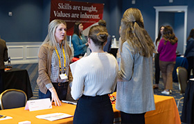 people talking at a career fair