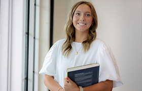 DBU student holding a book