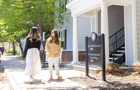 students walk past health services office